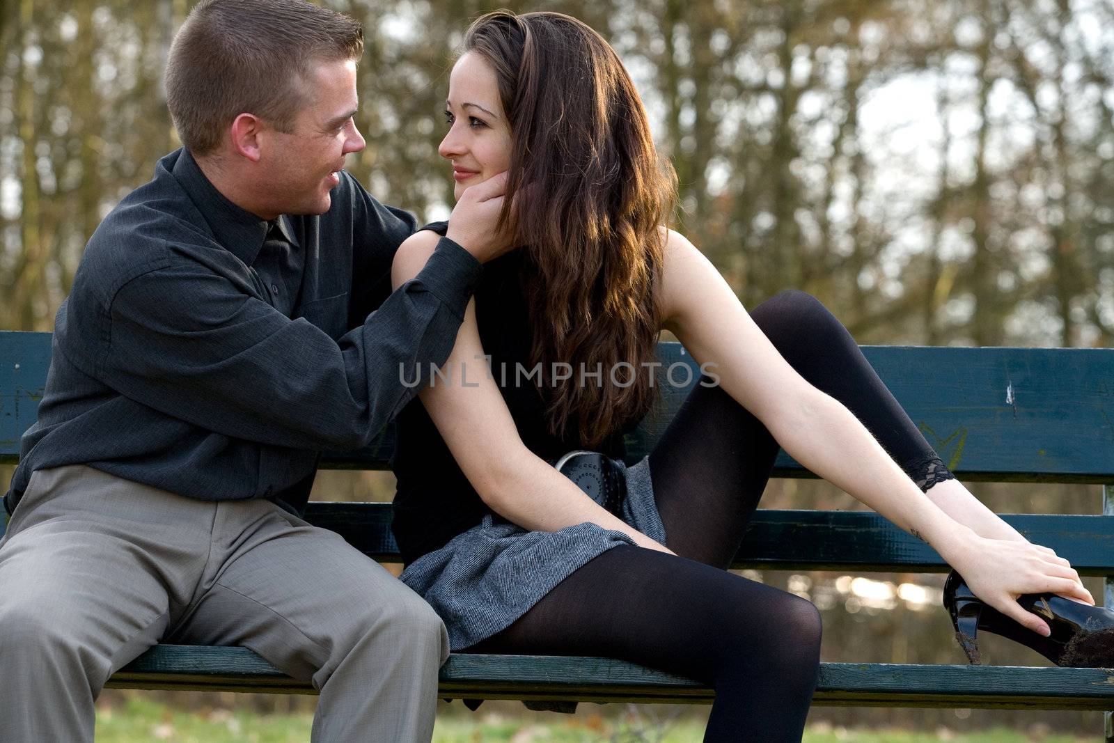 Man and girlfriend on a park bench caring