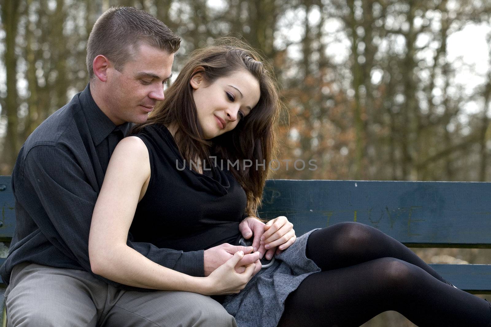 Man and girlfriend on a bench in a park with a depression