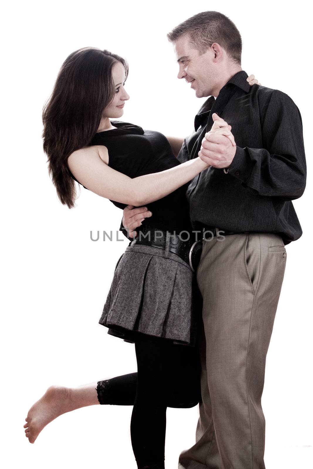 Studio shot of young loving couple dancing