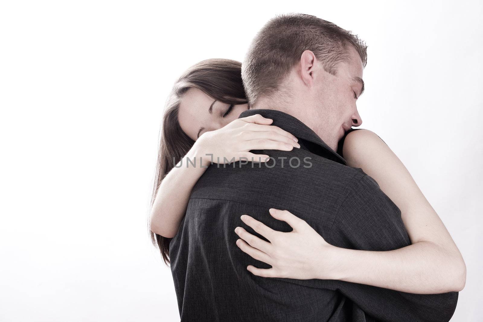 Studio shot of young loving couple caring