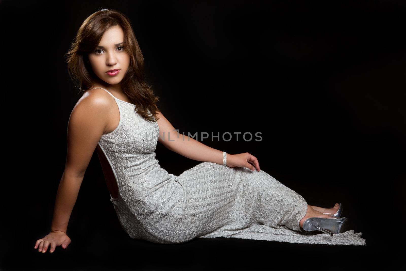 Beautiful young hispanic woman sitting