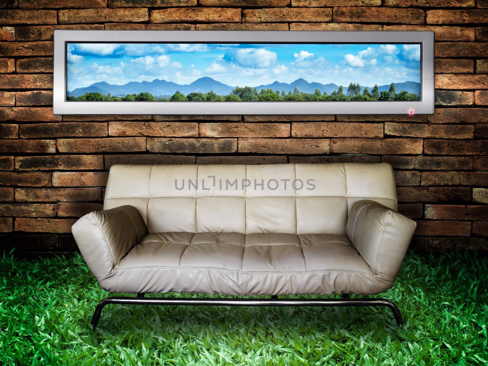 White sofa Brick Wall and Green Grass by nuttakit