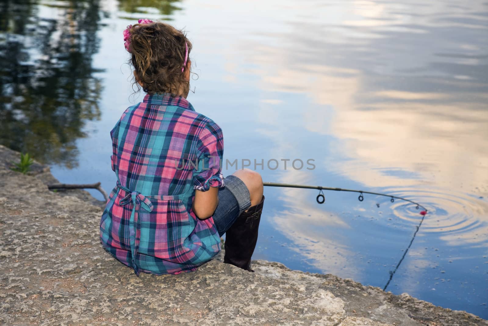 Fishing time - little girl by the lake.