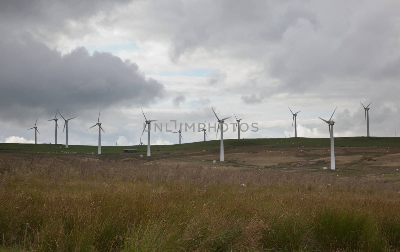 Wind turbines in wind farm on cloudy day in North Wales