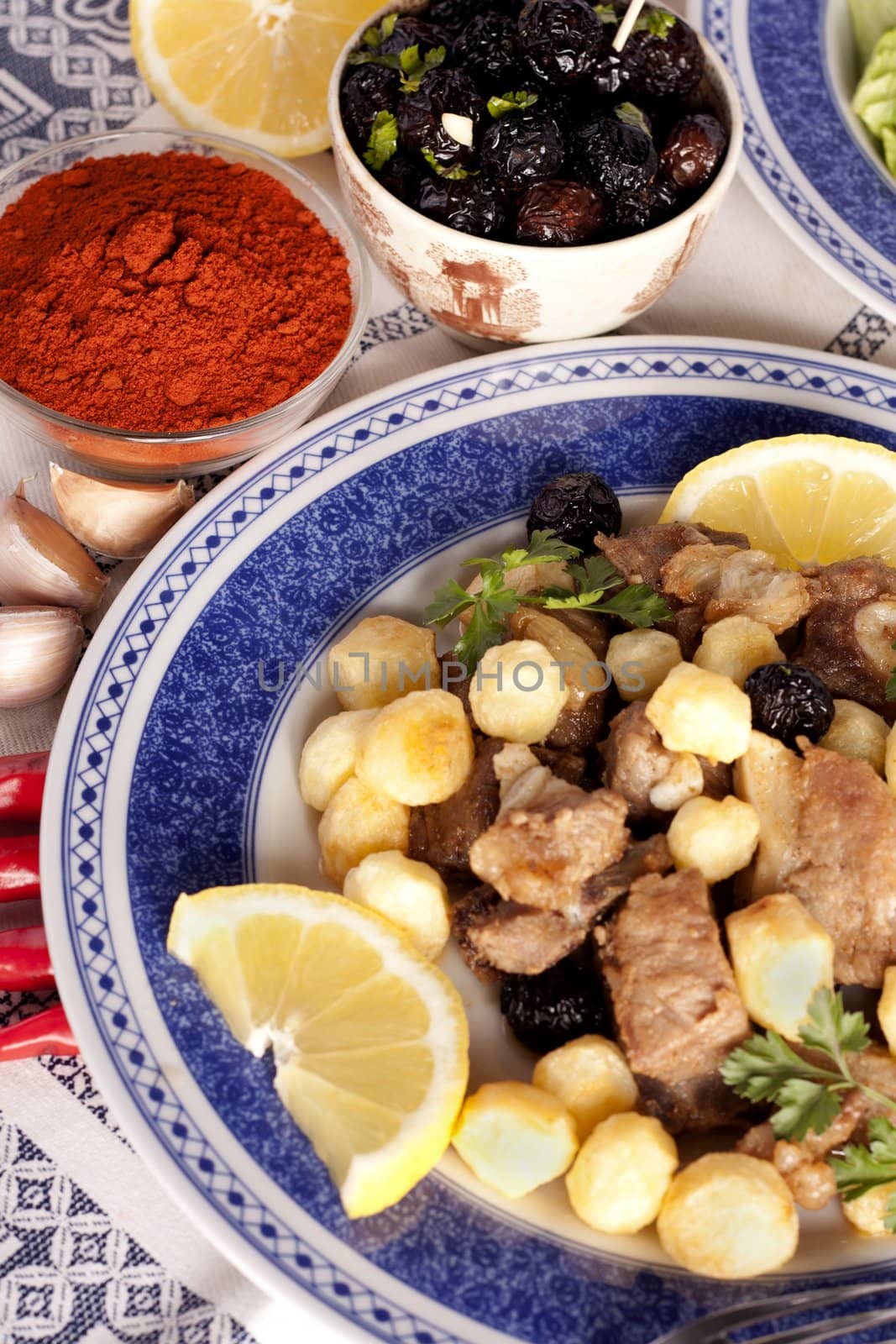 Close up view of a Portuguese meal of cooked meat with potatoes.