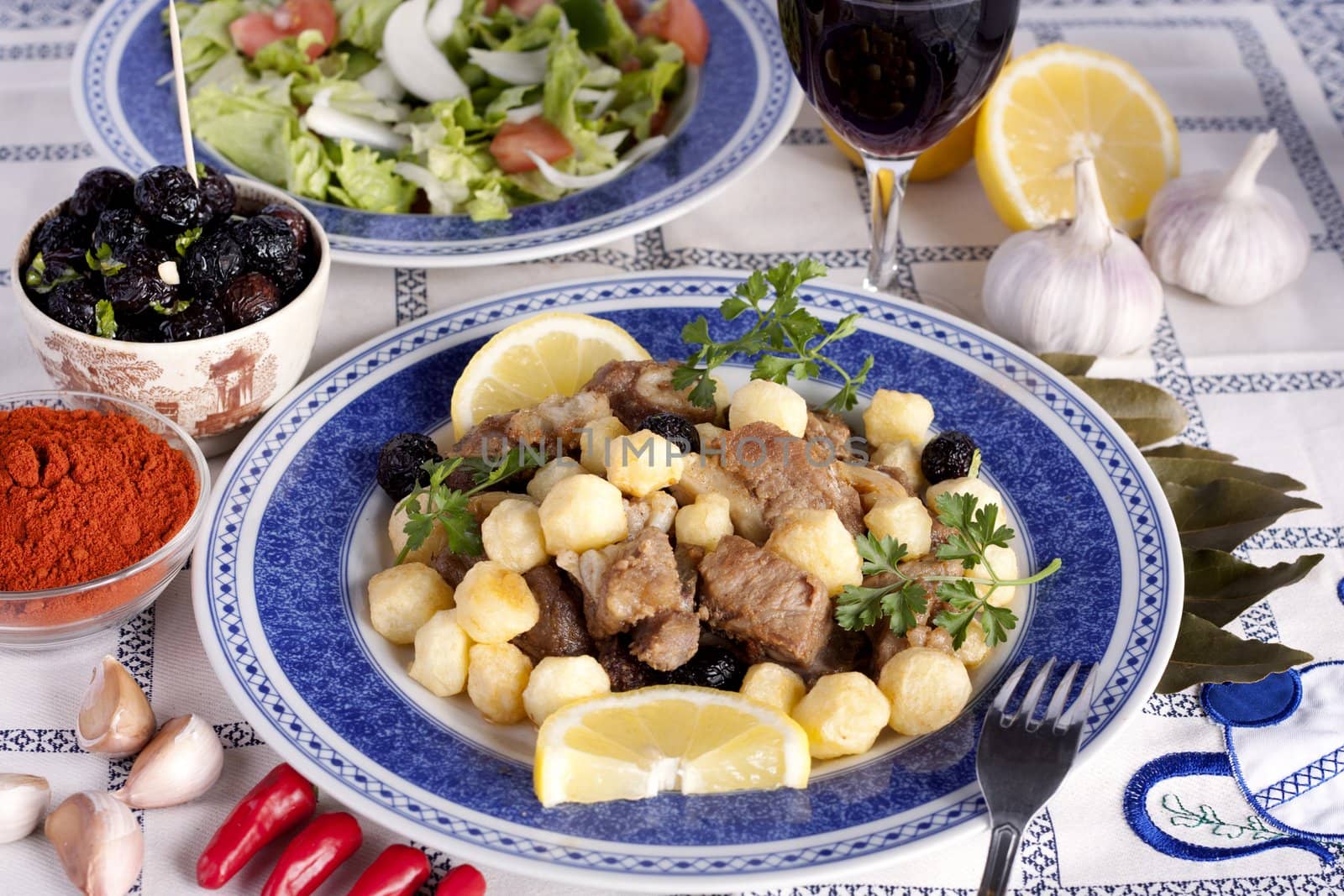 Close up view of a Portuguese meal of cooked meat with potatoes.
