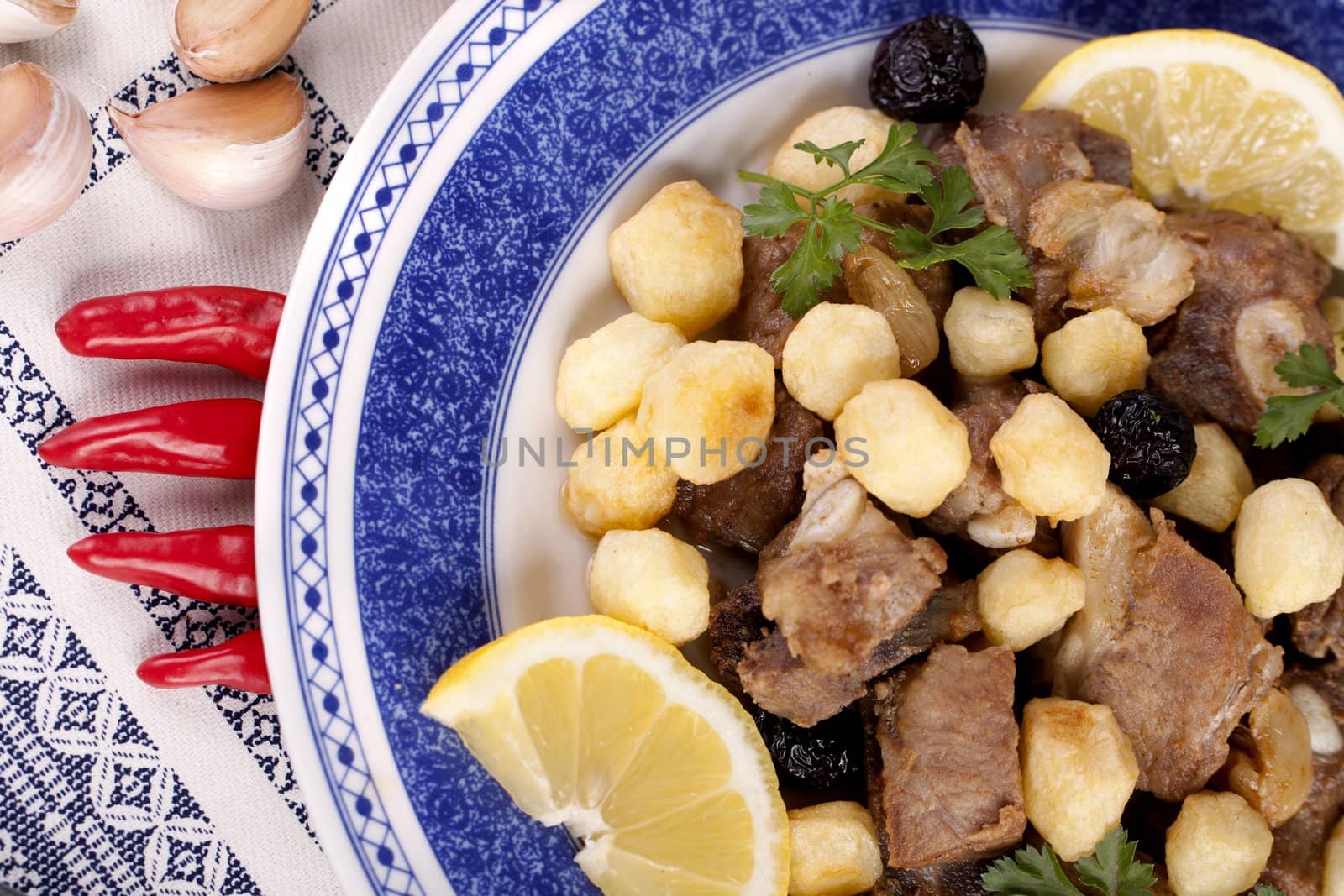 Close up view of a Portuguese meal of cooked meat with potatoes.