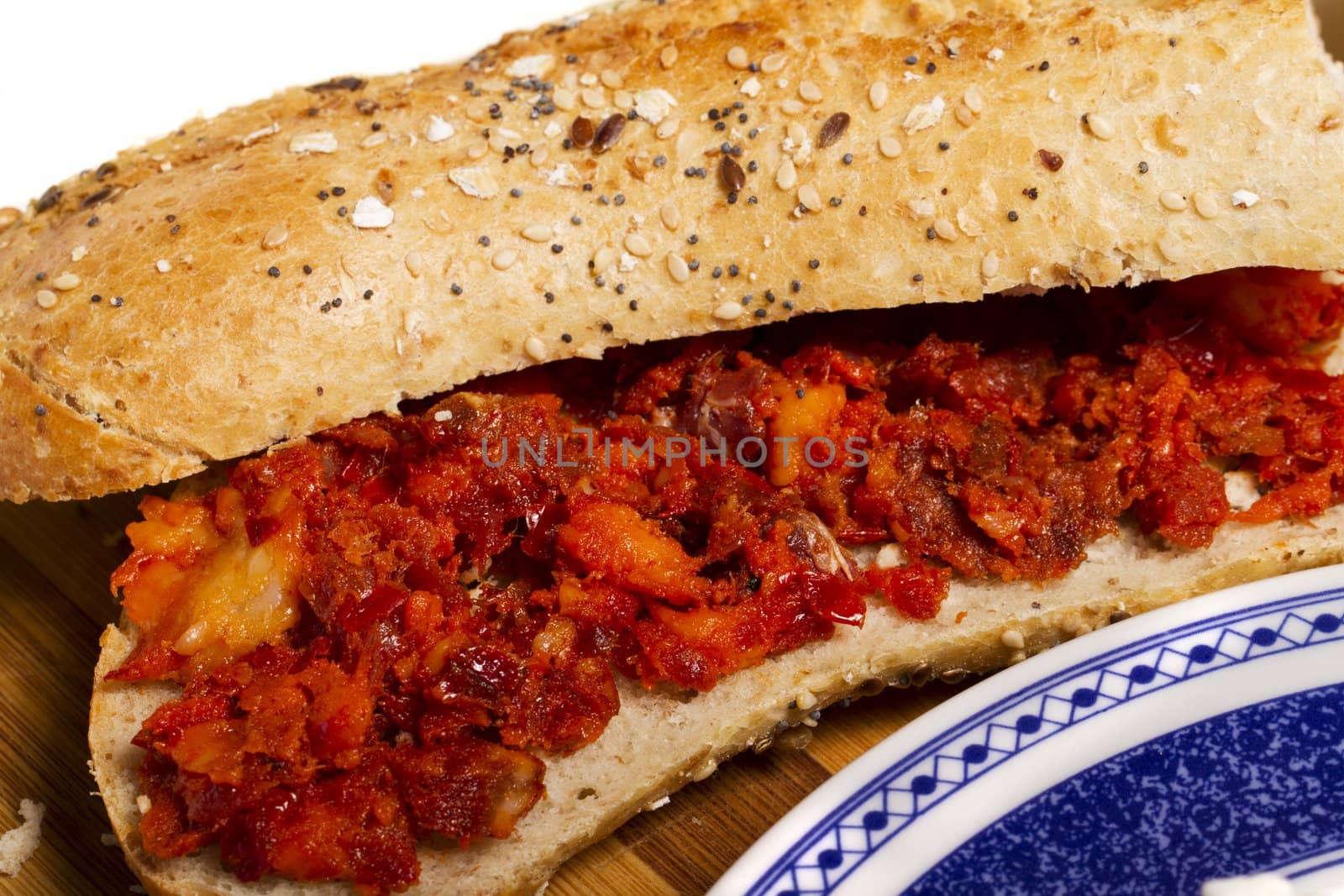View of a dish of fresh sandwich with seeds filled with Portuguese chorizo.