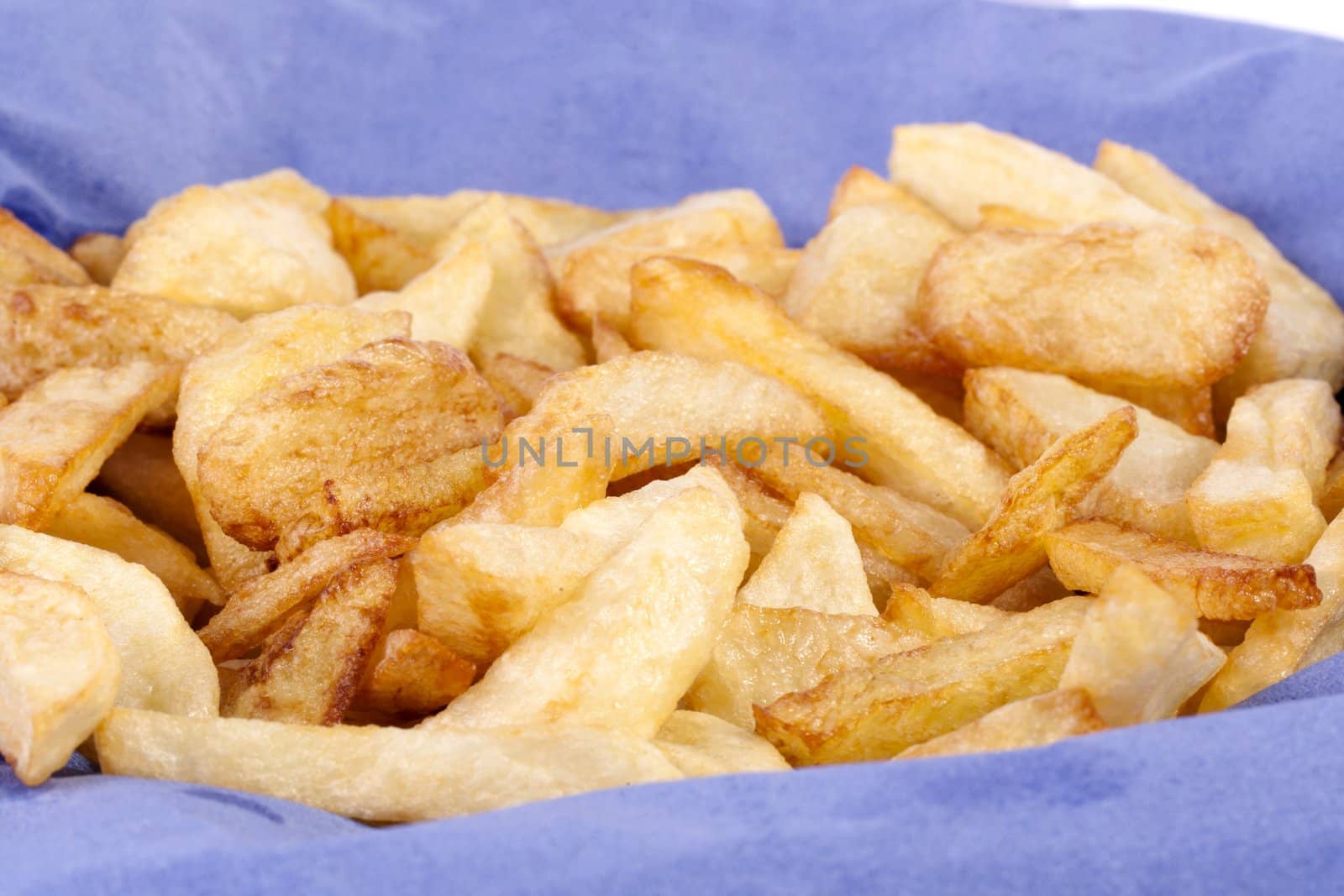 Close up view of a bunch of fried potatoes in slices. 