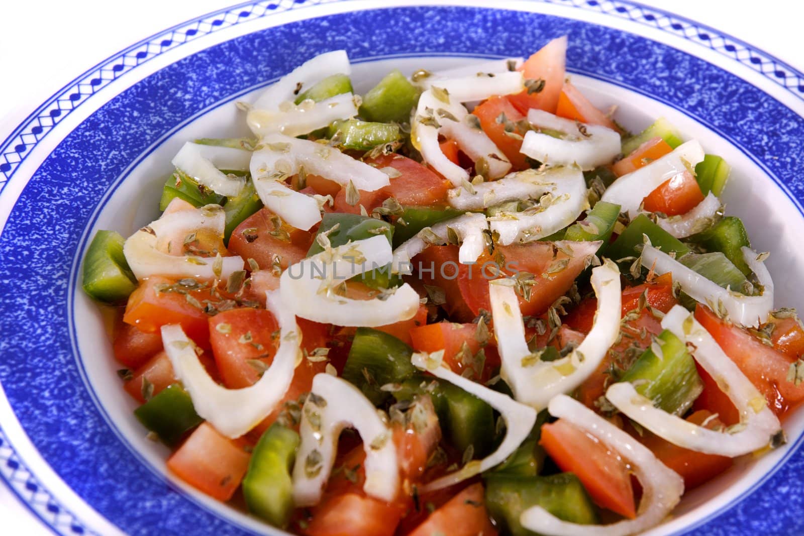Detail view of a fresh made Mediterranean salad isolated on a white background.
