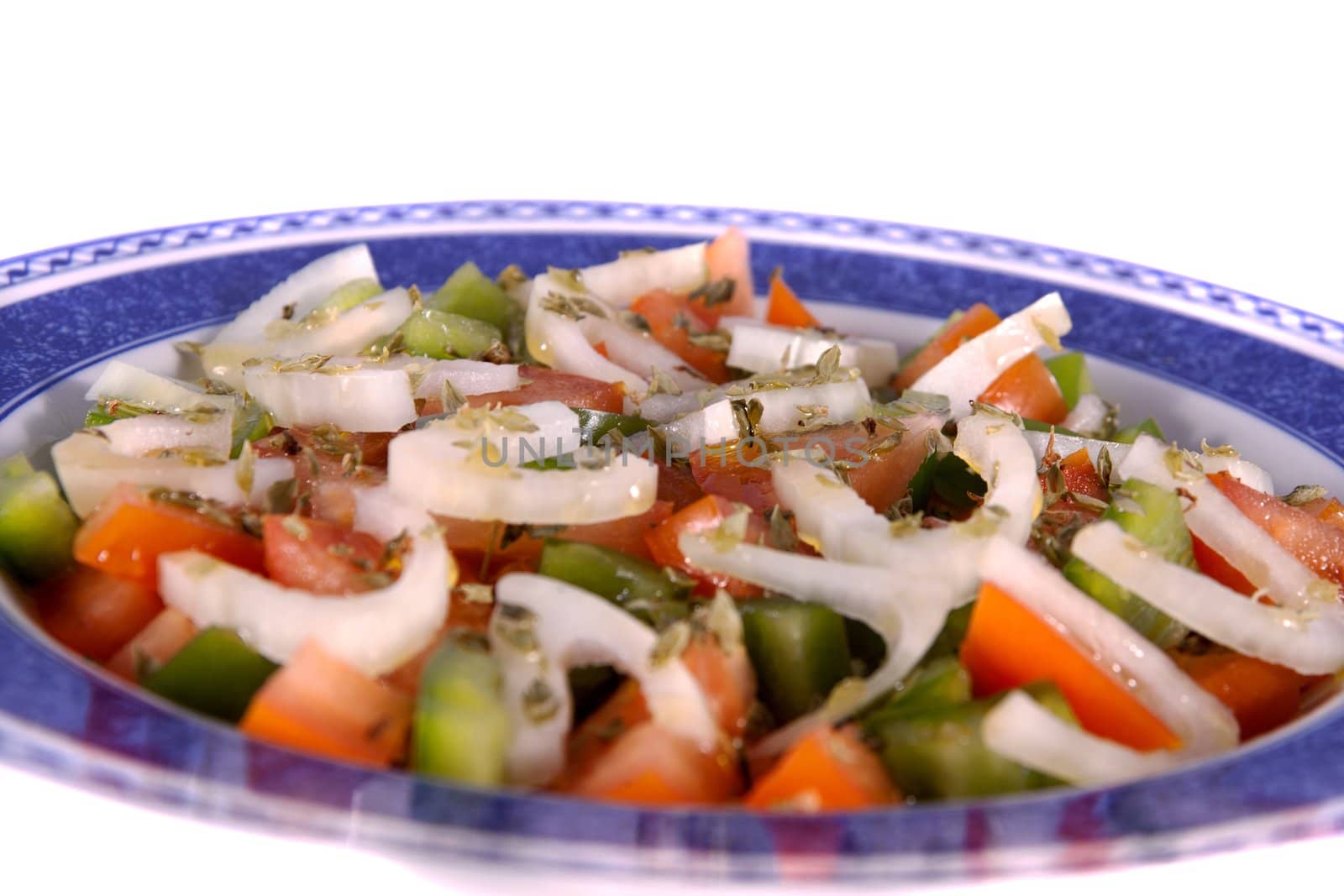 Detail view of a fresh made Mediterranean salad isolated on a white background.