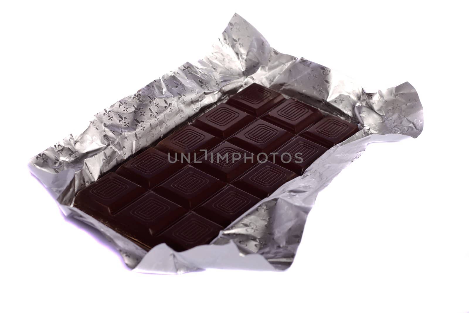 Close view of a dark chocolate bar isolated on a white background.