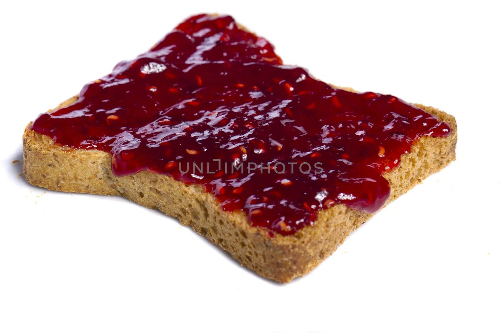 Close view of a toasted bread with berry jam spread  isolated on a white background.