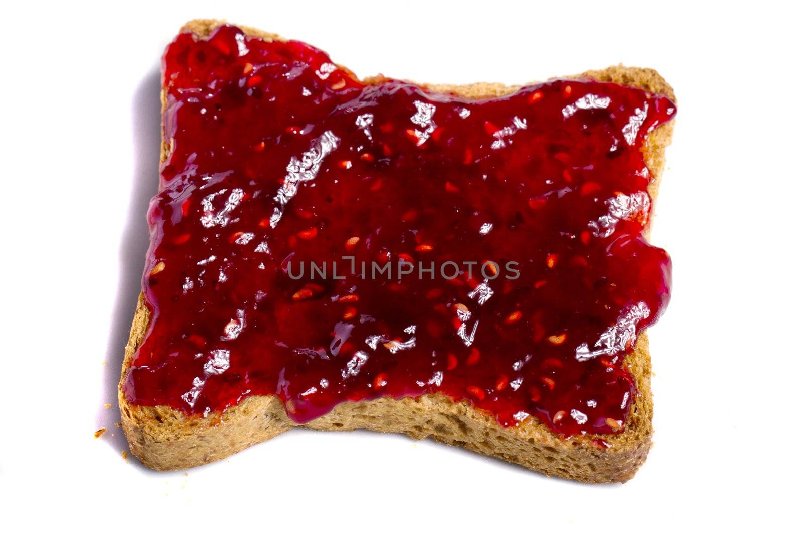 Close view of a toasted bread with berry jam spread  isolated on a white background.