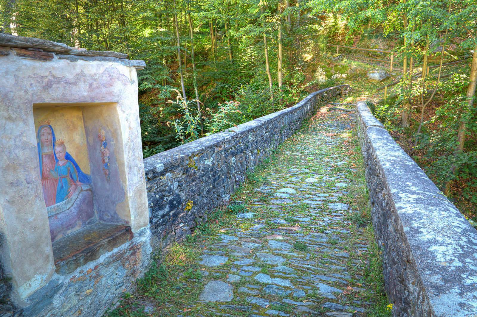 Bridge of a foot and mule path in an enchanted wood with a Lady Chapel