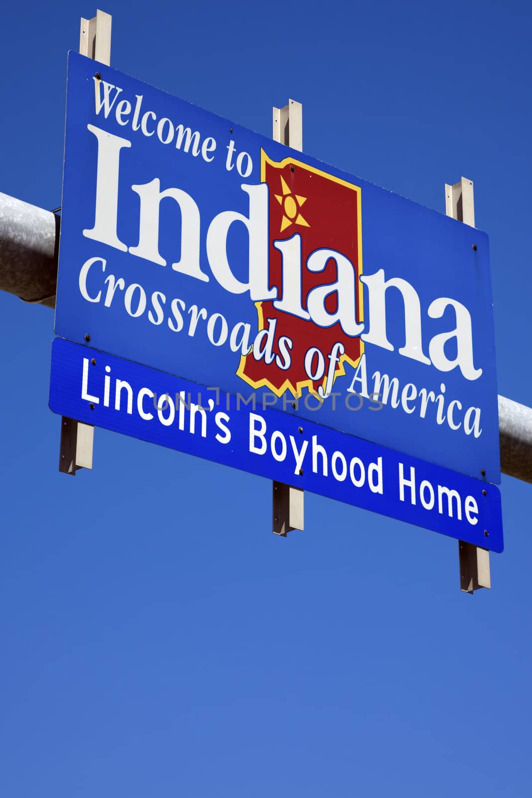 Welcome to Indiana road sign against blue sky.