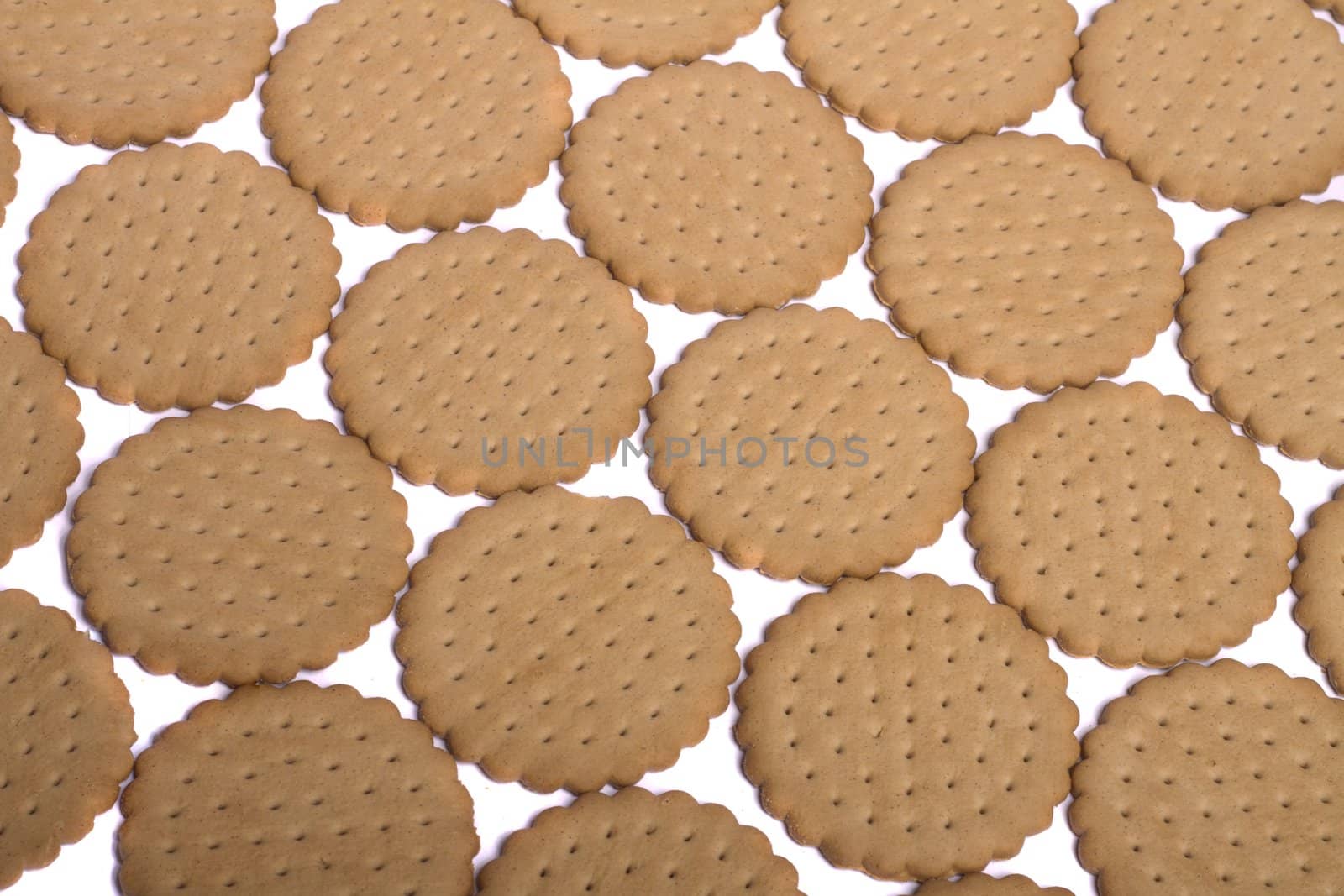 View of many round biscuits isolated on a white background.