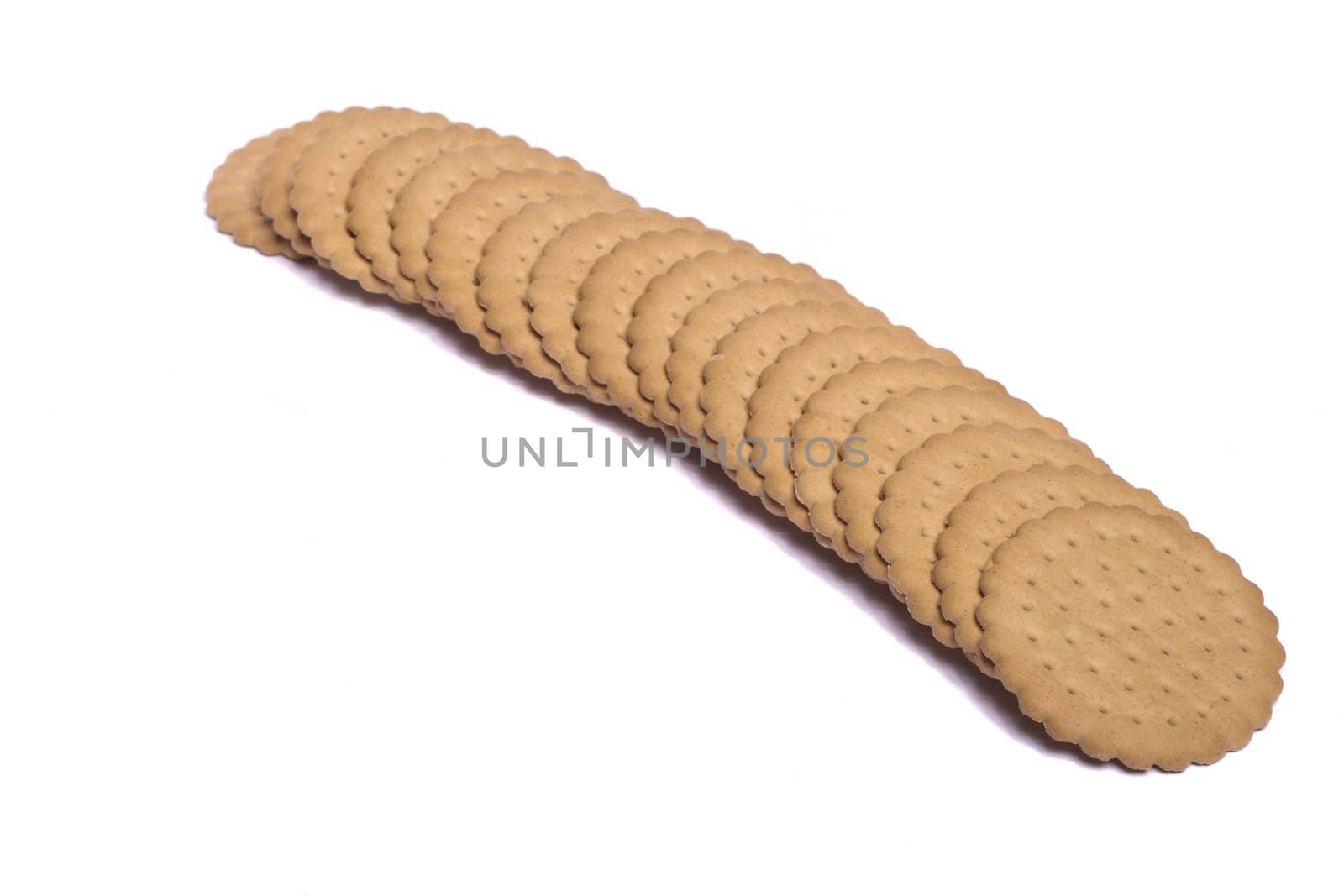 View of many round biscuits isolated on a white background.