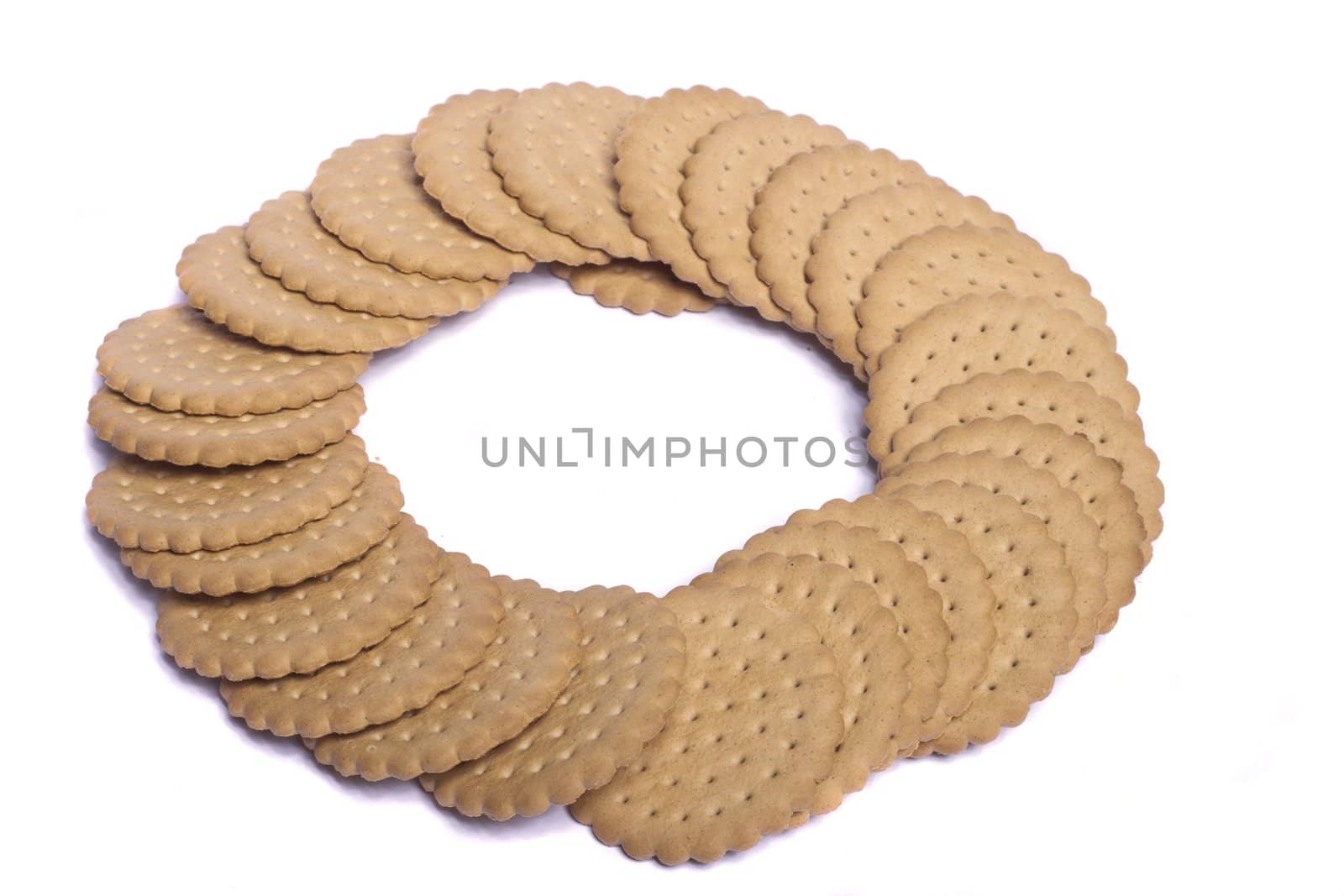 View of many round biscuits isolated on a white background.