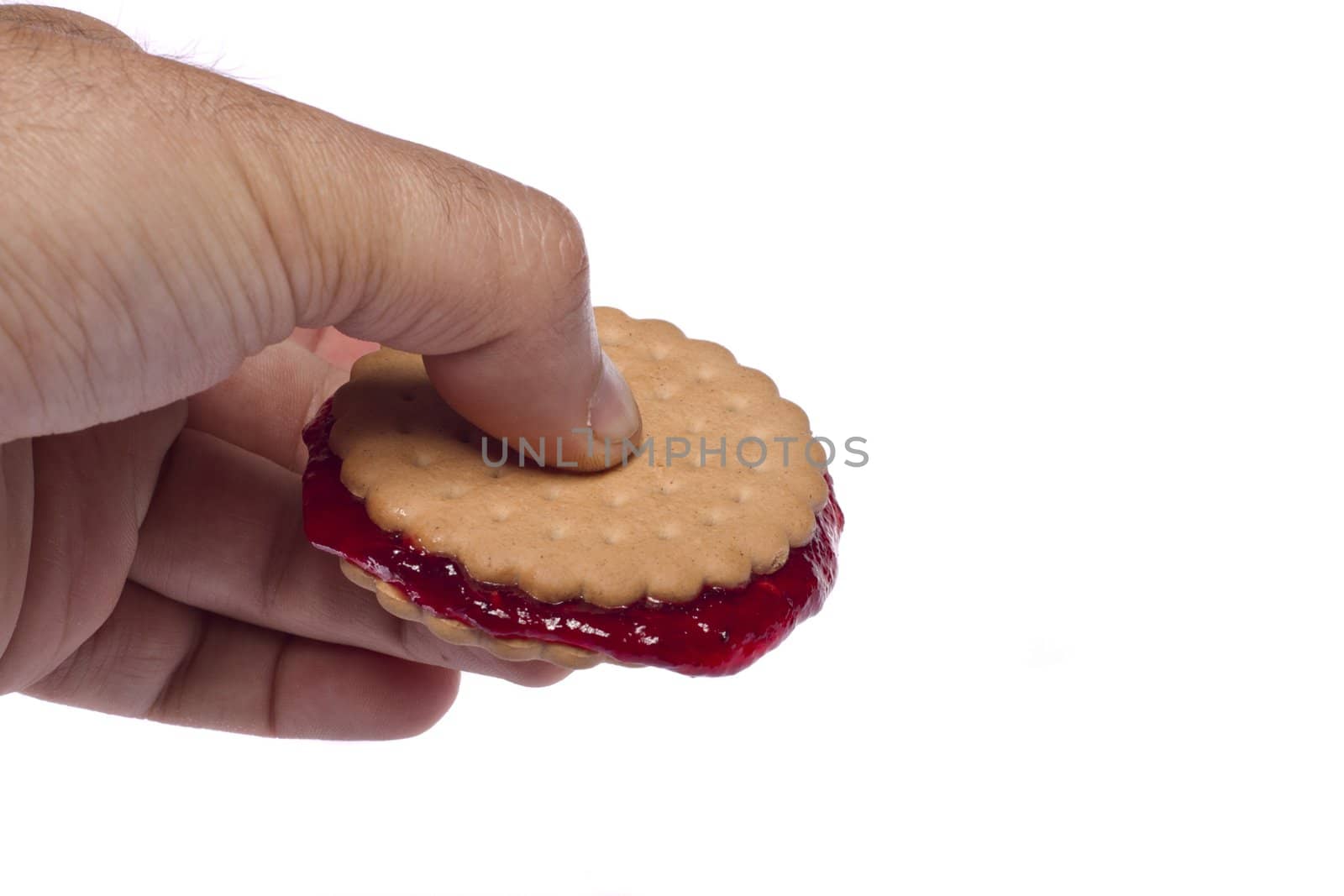 View of a round biscuit isolated on a white background with berry jam.