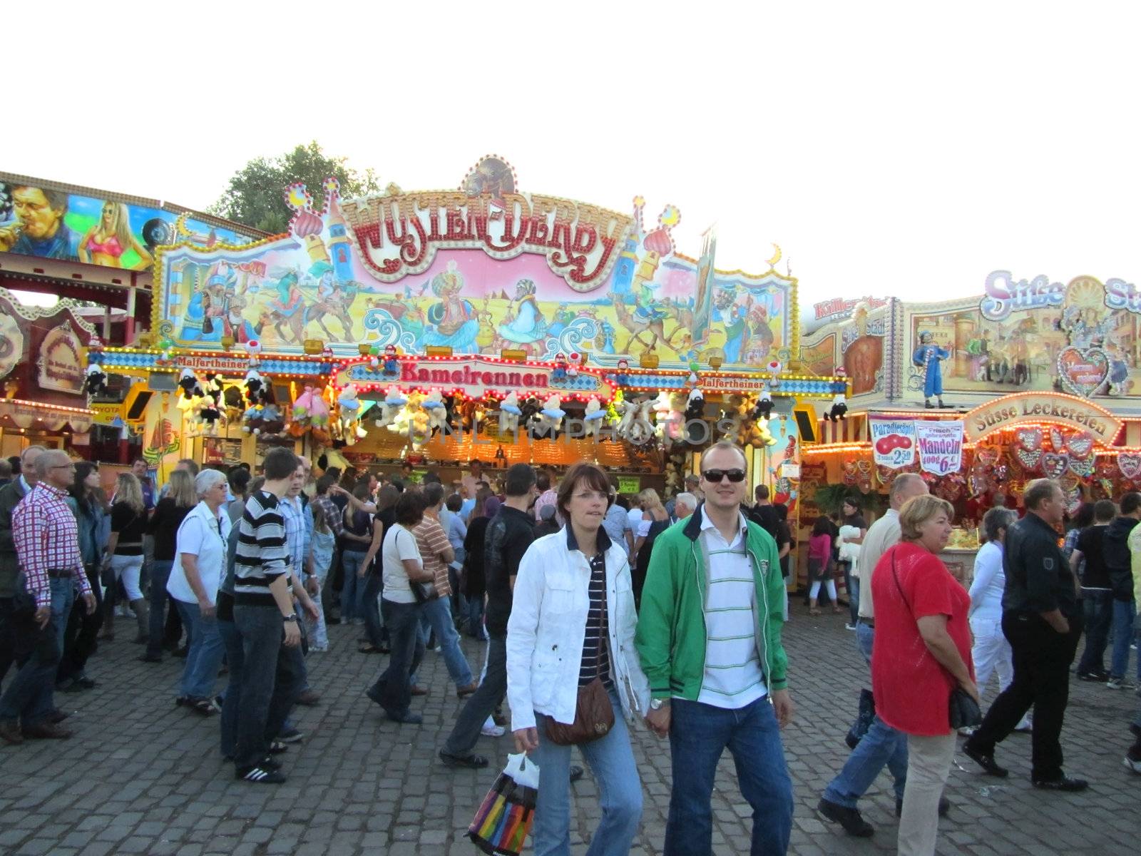 DUSSELDORF, GERMANY - JULY 24: Unidentified visitors near a horse racing game at Kirmes on July 24, 2010 in Dusseldorf, Germany. Kirmes is the biggest summer fair on the north Rhein in Germany.              