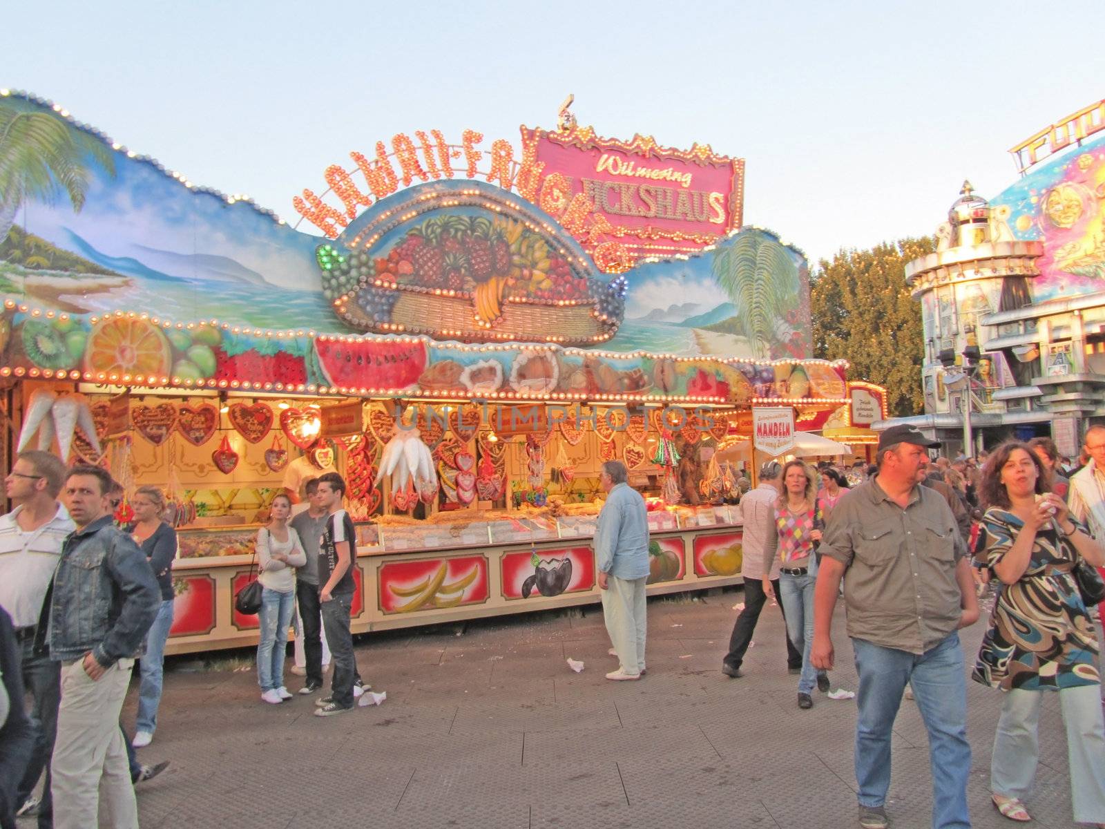DUSSELDORF, GERMANY - JULY 24: Unidentified visitors near a gingerbread food stall at Kirmes on July 24, 2010 in Dusseldorf, Germany. Kirmes is the biggest summer fair on the north Rhein in Germany.