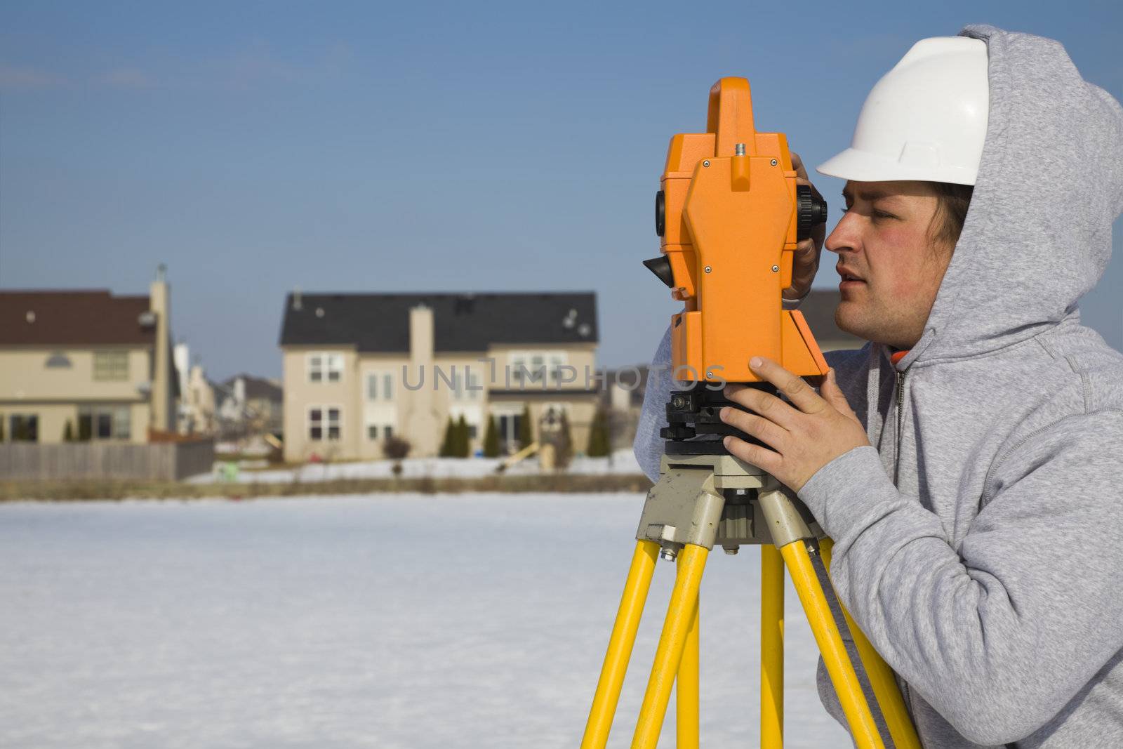 Land surveying during the winter - suburban area.