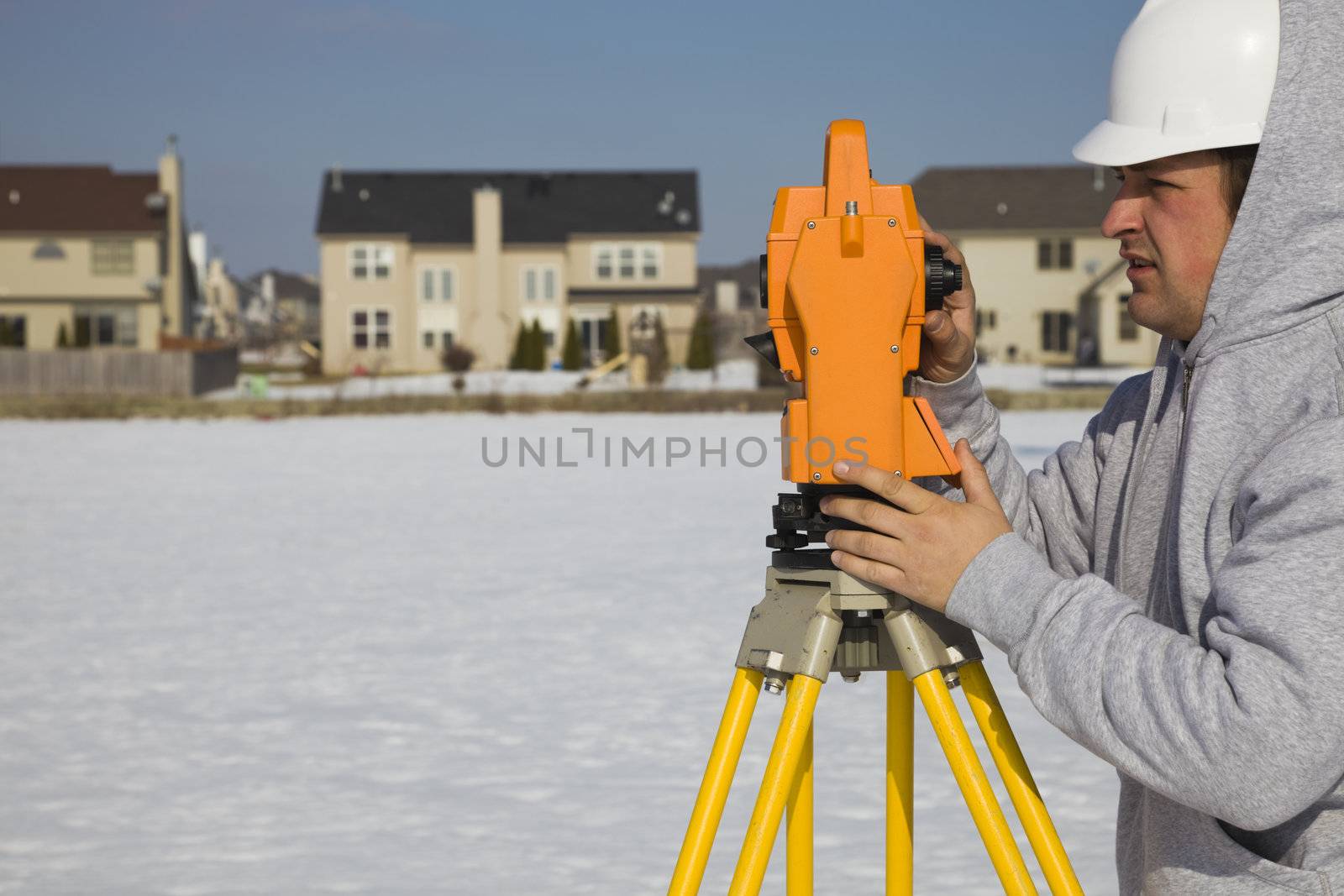 Land surveying during the winter - suburban area.