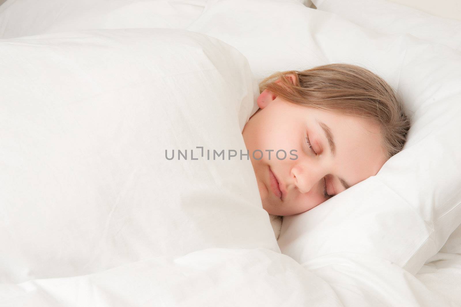 a pretty young woman asleep in bed