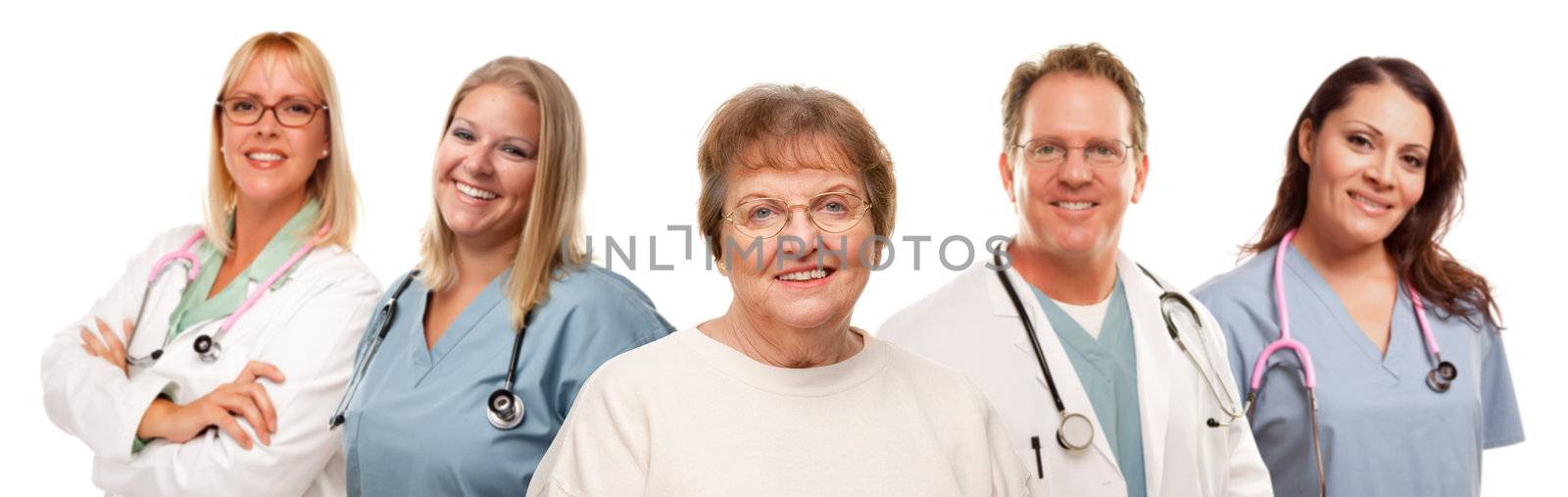 Smiling Senior Woman with Medical Doctors and Nurses Behind by Feverpitched