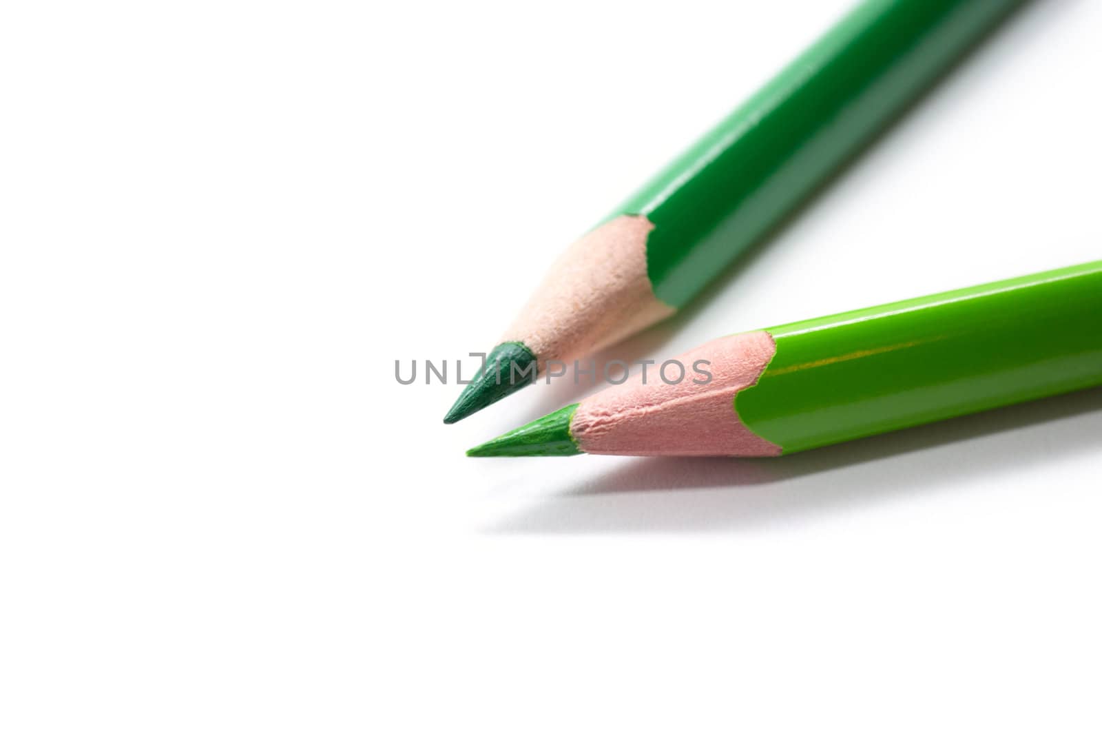 Two green pencils isolated on white