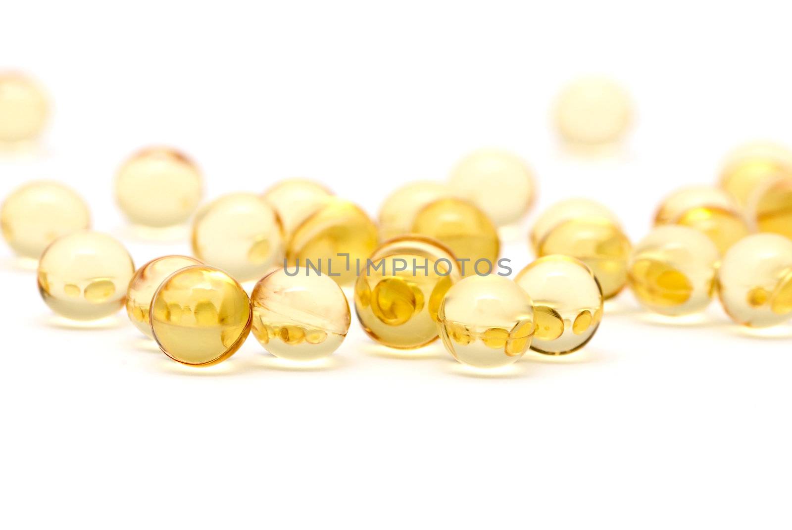 Transparent yellow capsules isolated on white