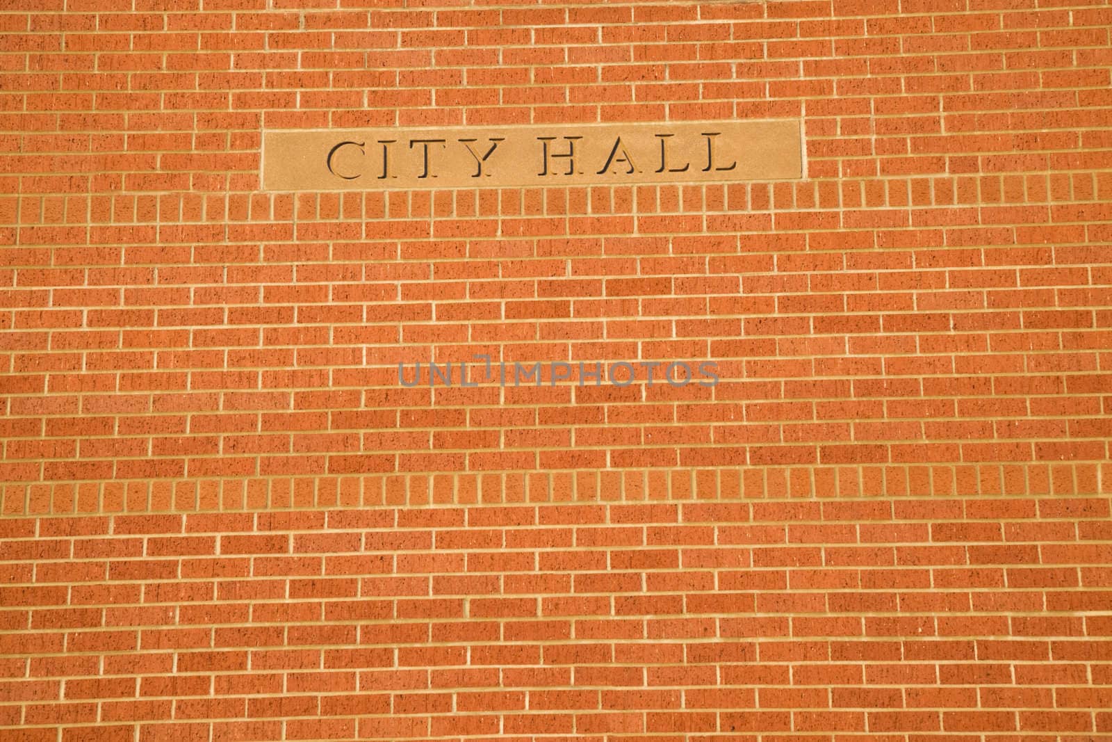 City Hall sign on the brick wall.