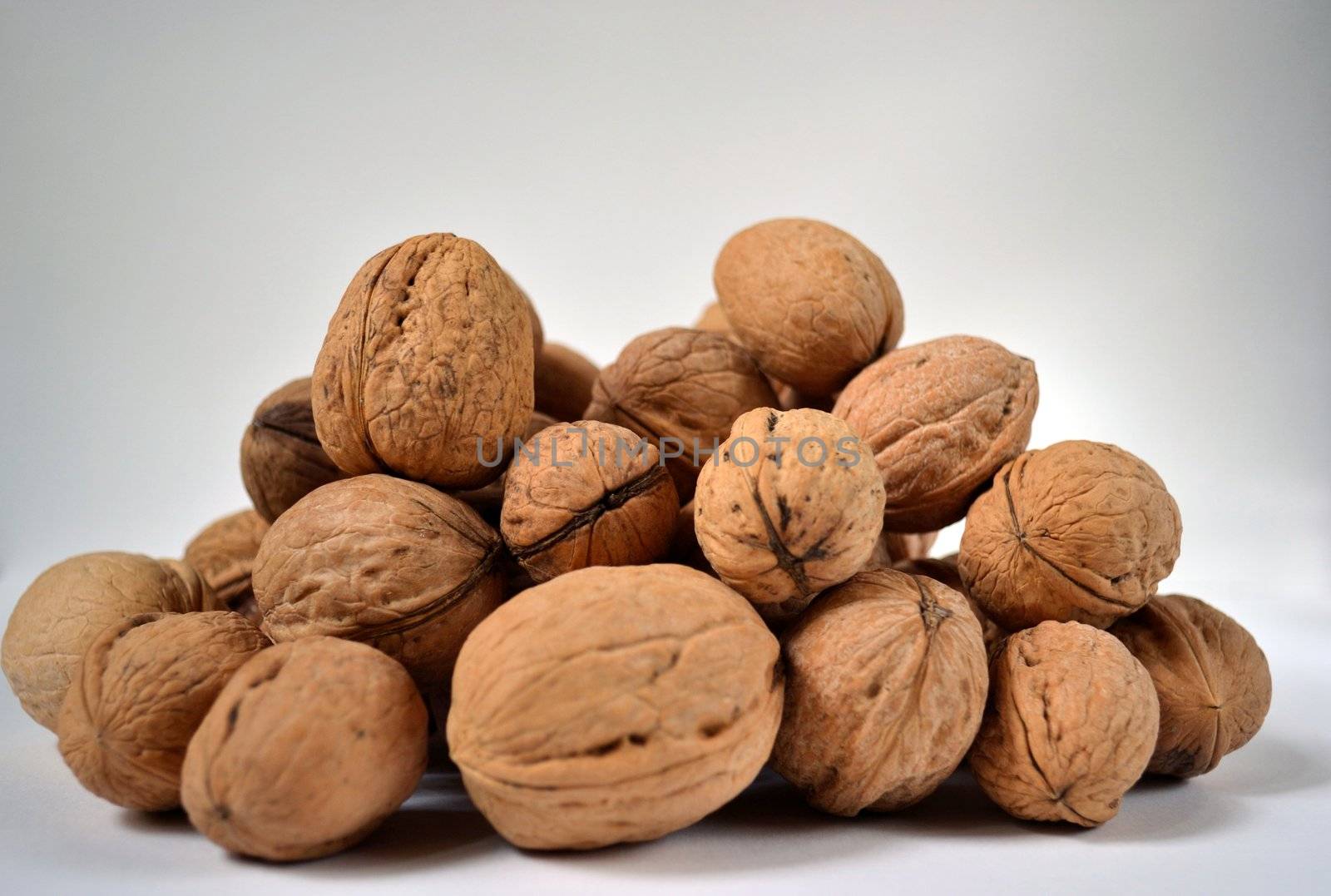 Little heap of Greek nuts over the white background