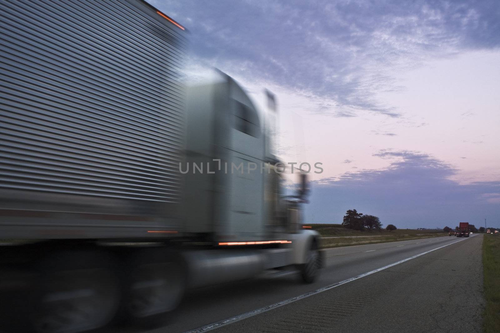Truck driving during sunset by benkrut