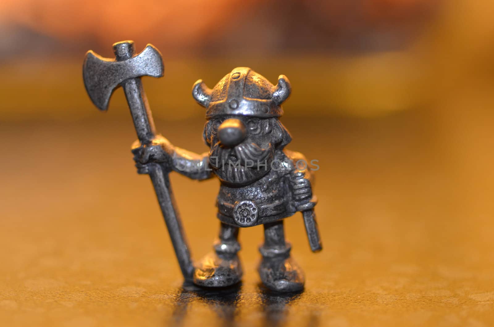 A viking figurine holding an axe,