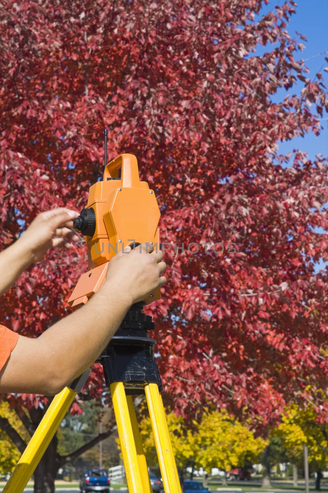 Hands on theodolite - land surveying during fall time.