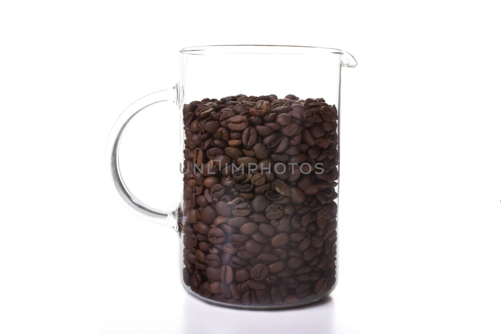 Glass pitcher of coffee beans isolate on white background.