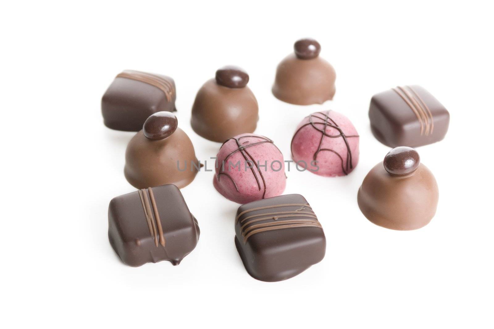 Ten gourmet chocolates isolated on white.
