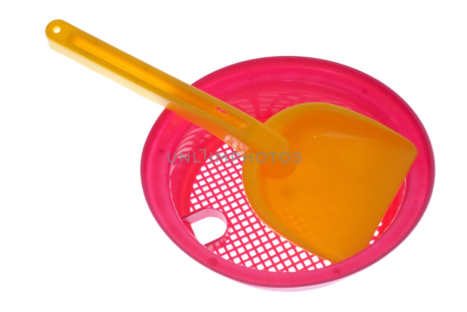 Yellow and pink sandbox toys, sieve and shovel, isolated on white background