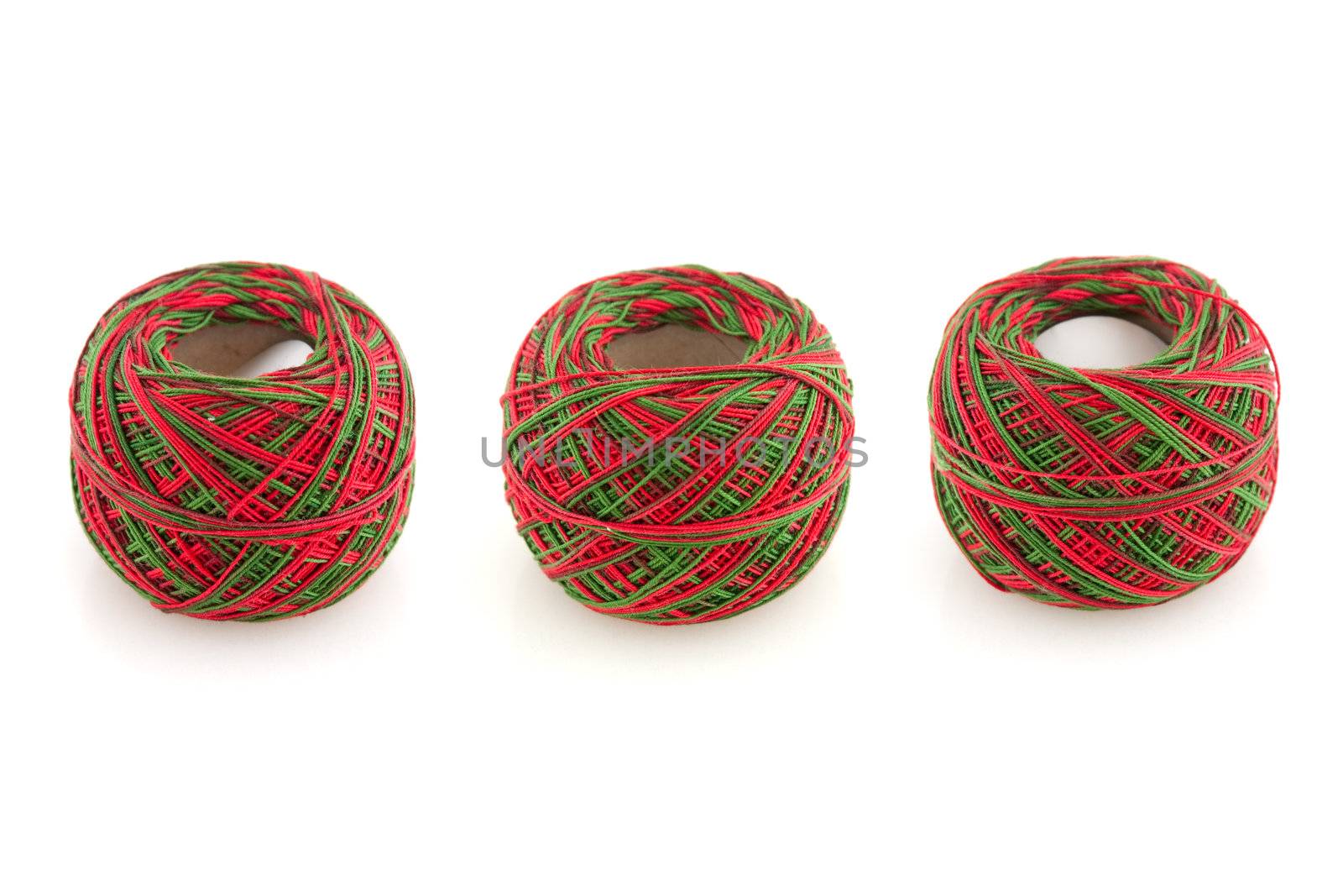 Three cotton spools isolated on a white background.