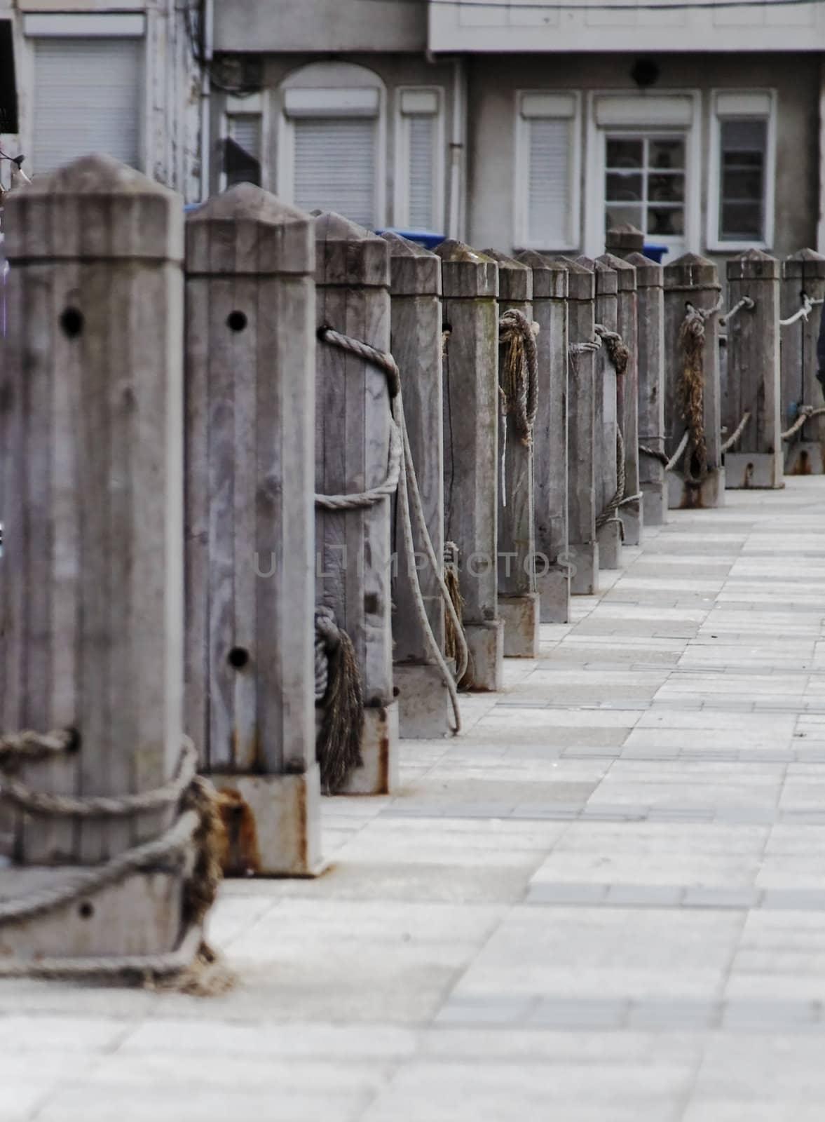 vertical portrait of quayside wharf berths bollards quays and public footpath, crop space and copy area