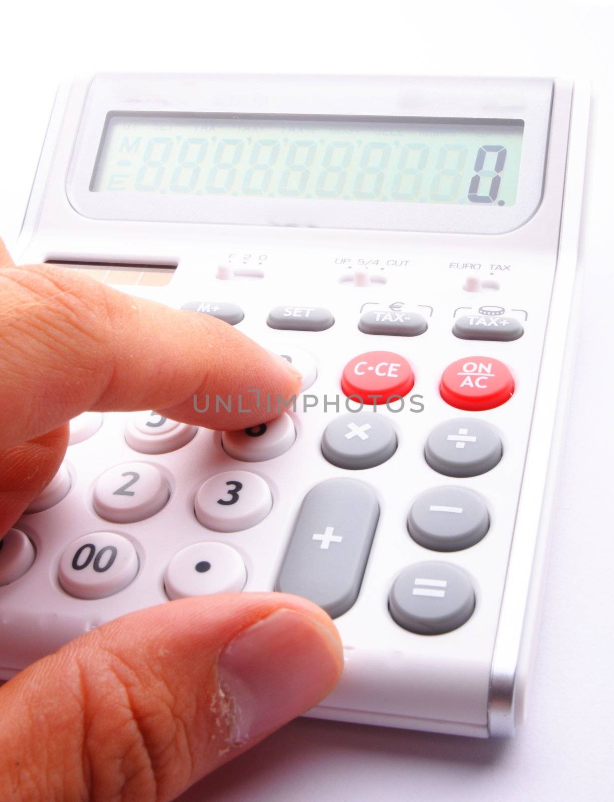 adding up figures concept with modern white calculator in office