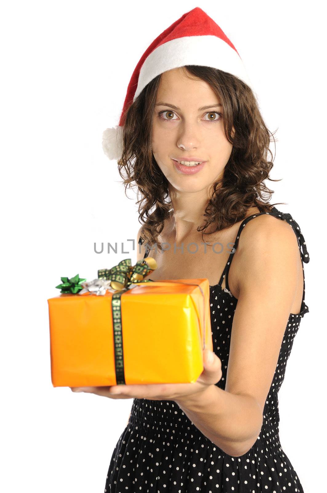 Pretty young woman with santa hat holding christmas gift