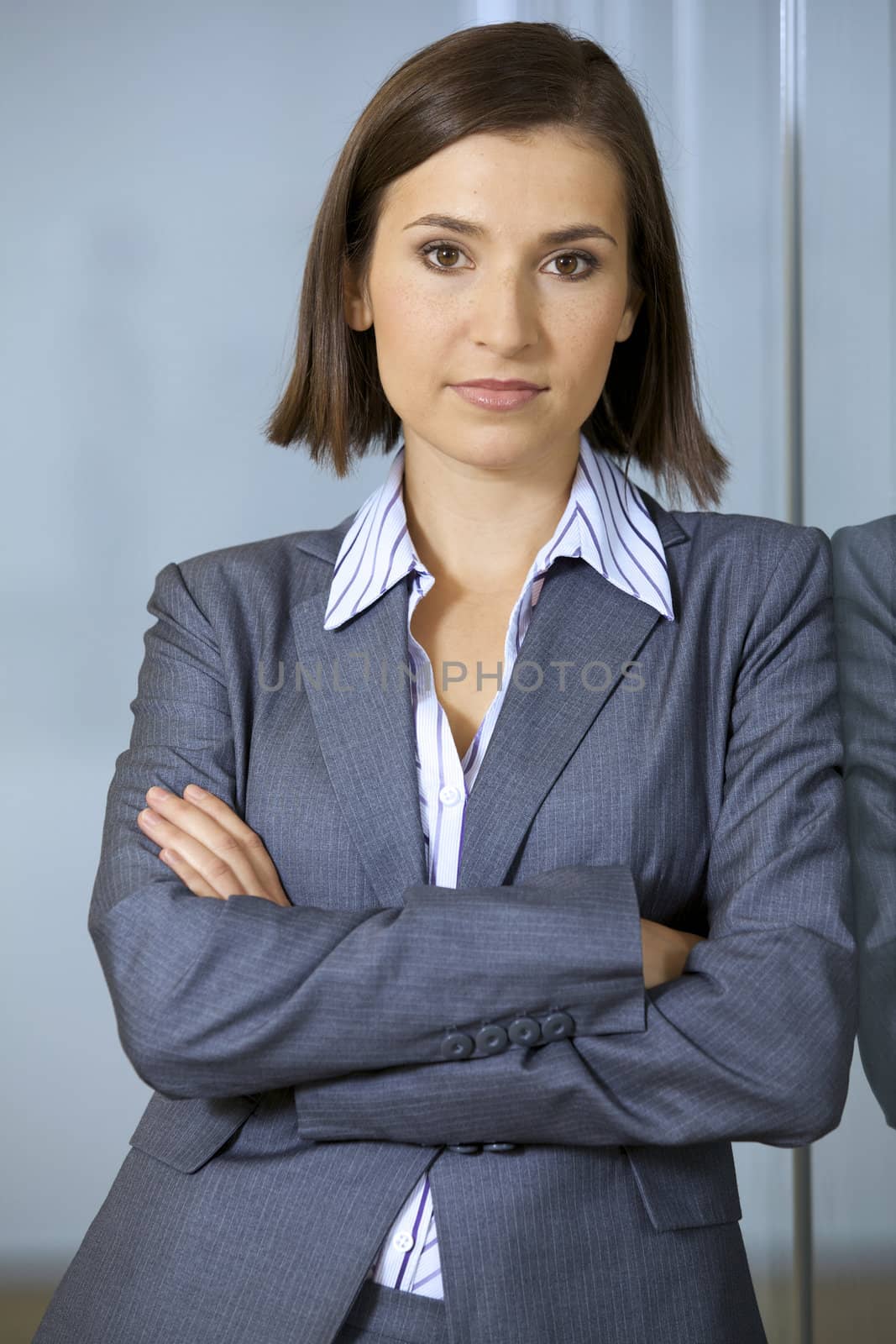 Portrait of businesswoman standing with arms crossed