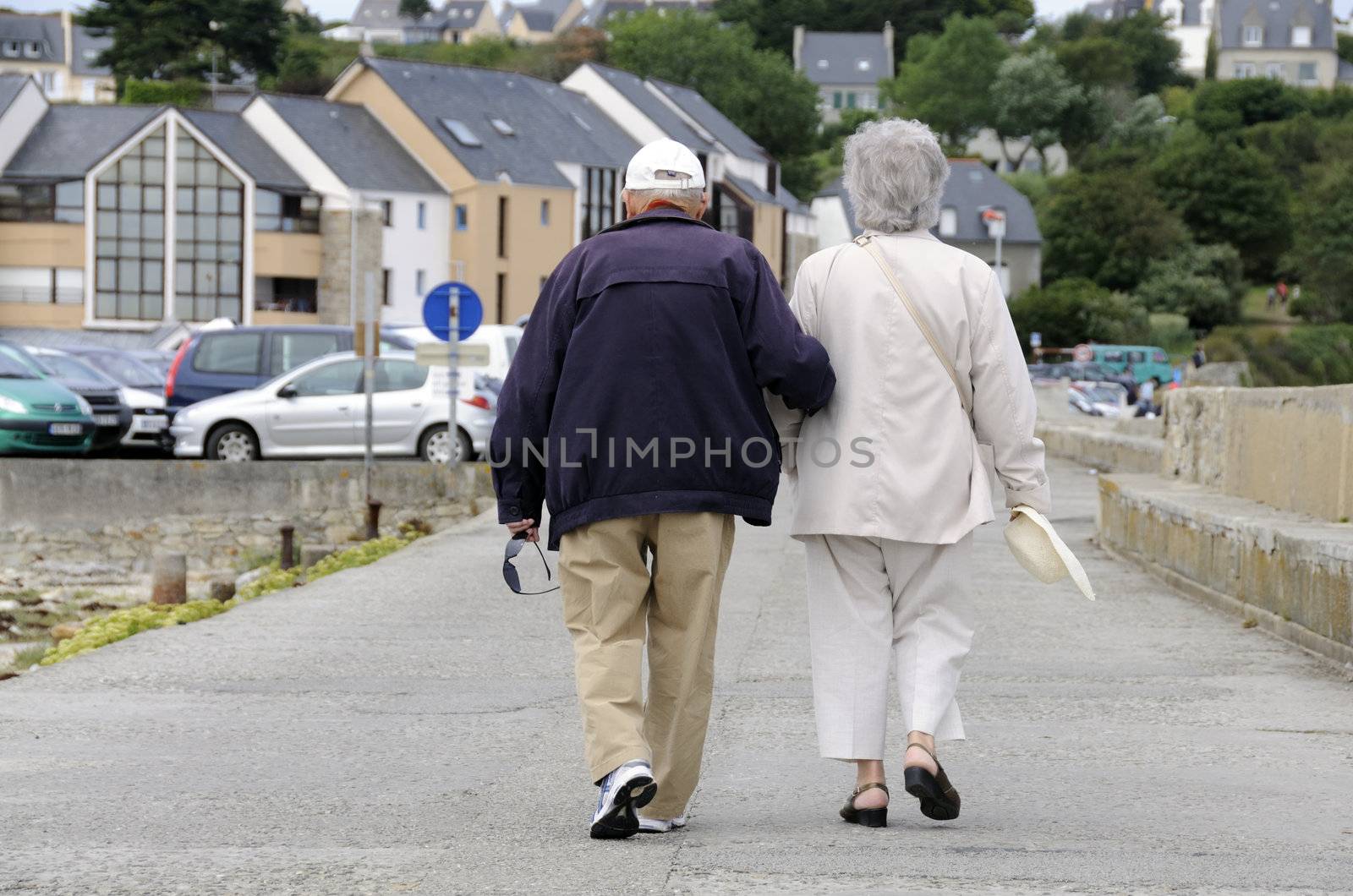 Senior couple walking together holding their hands.