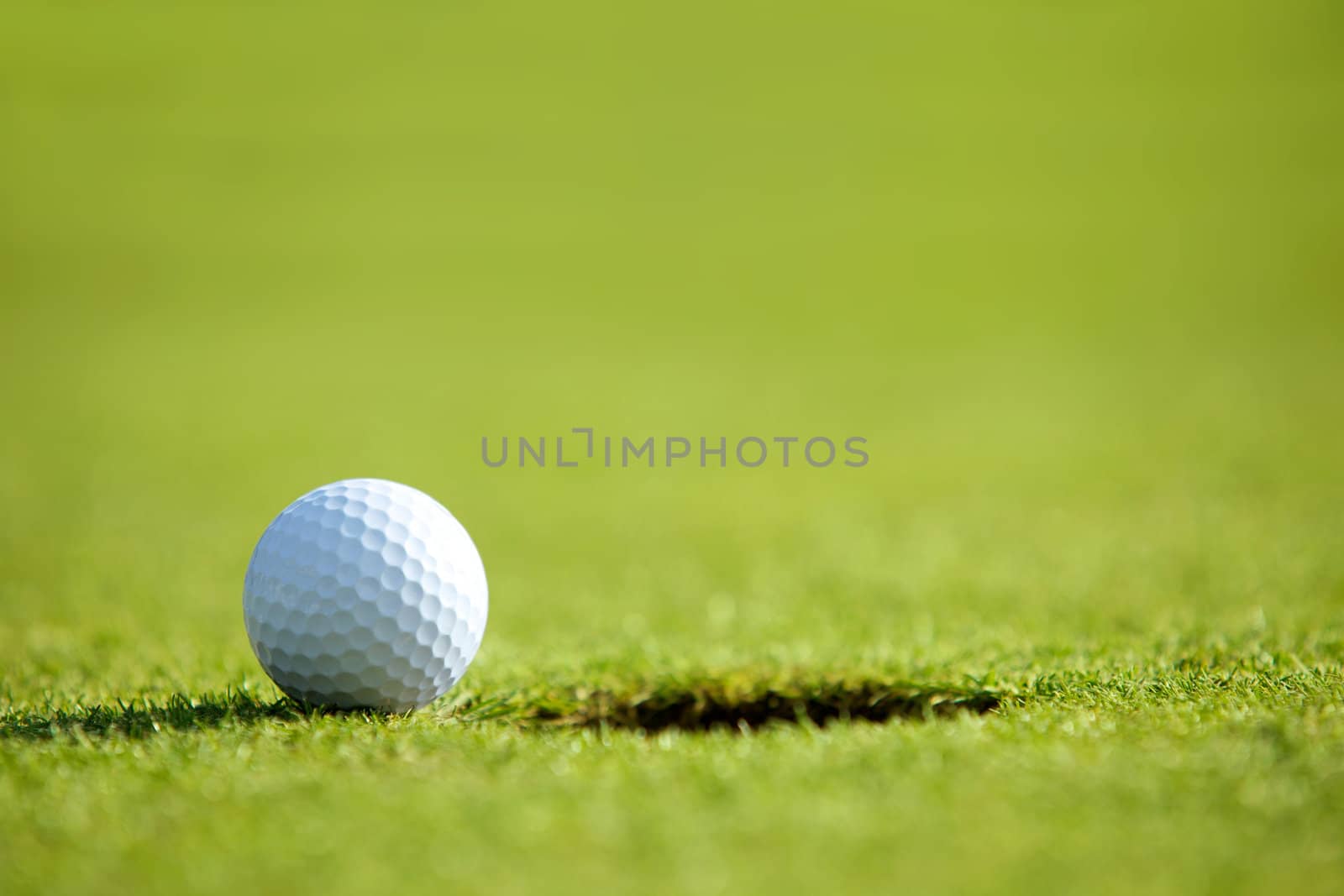 Golf ball near hole
