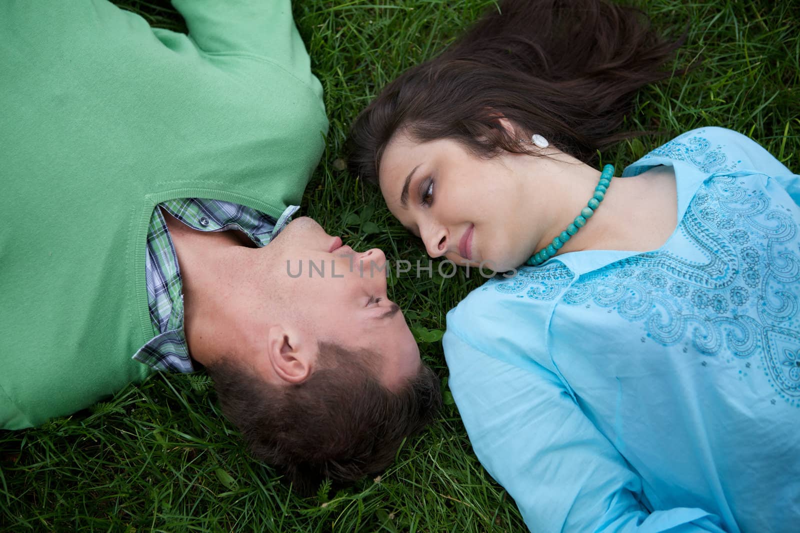 Young couple lying on grass