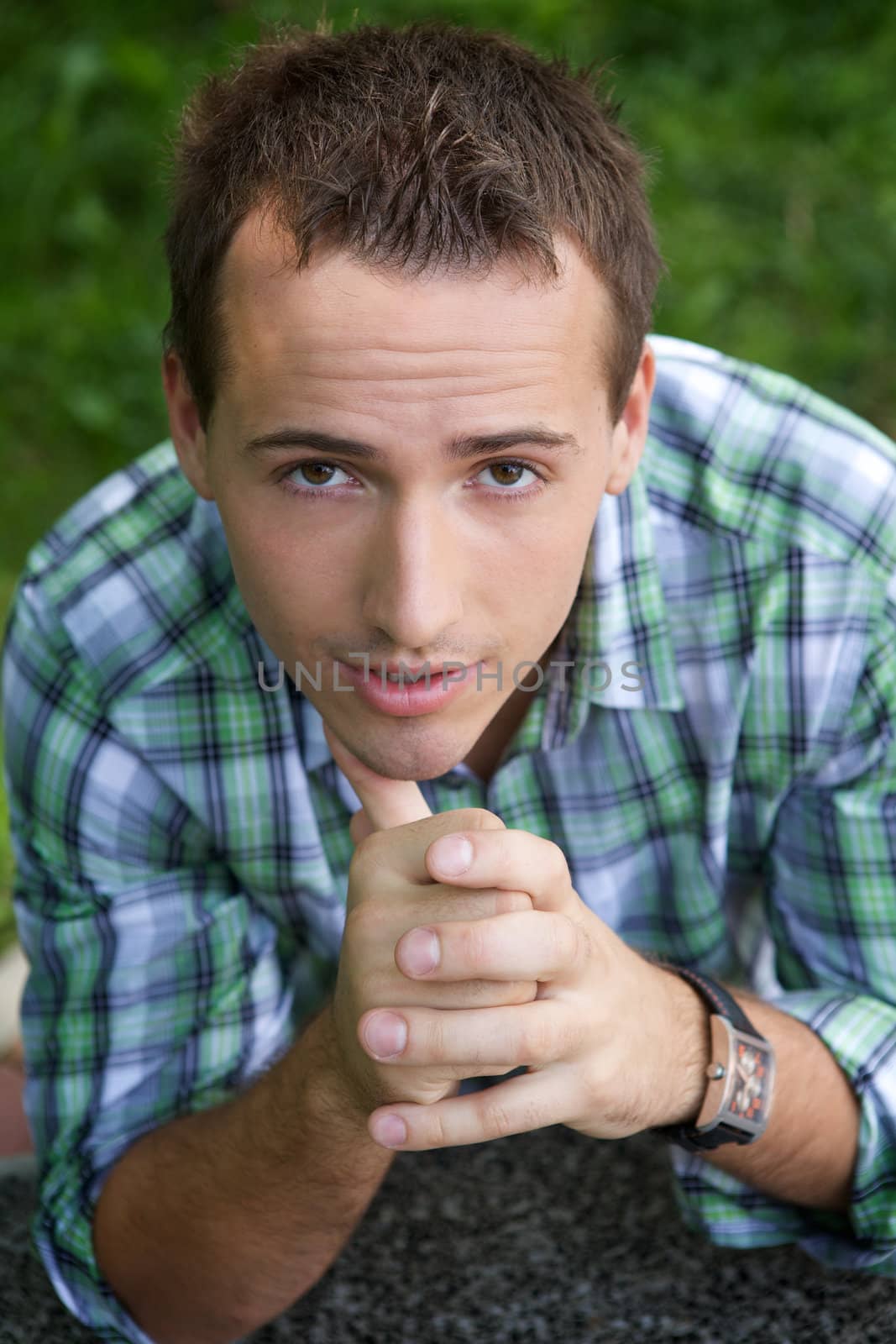 Portrait of young man with hand on chin