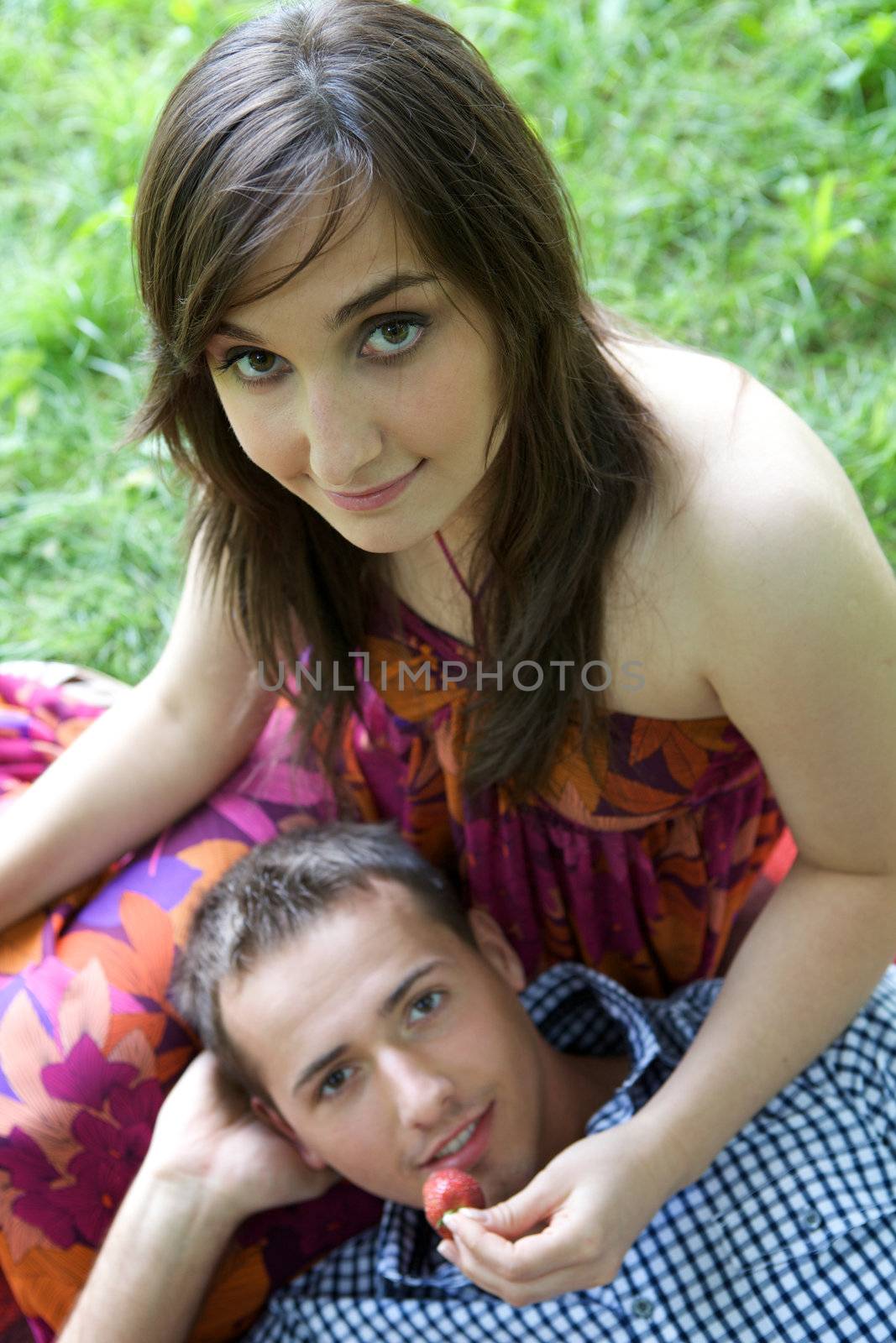 Portrait of young couple relaxing in park